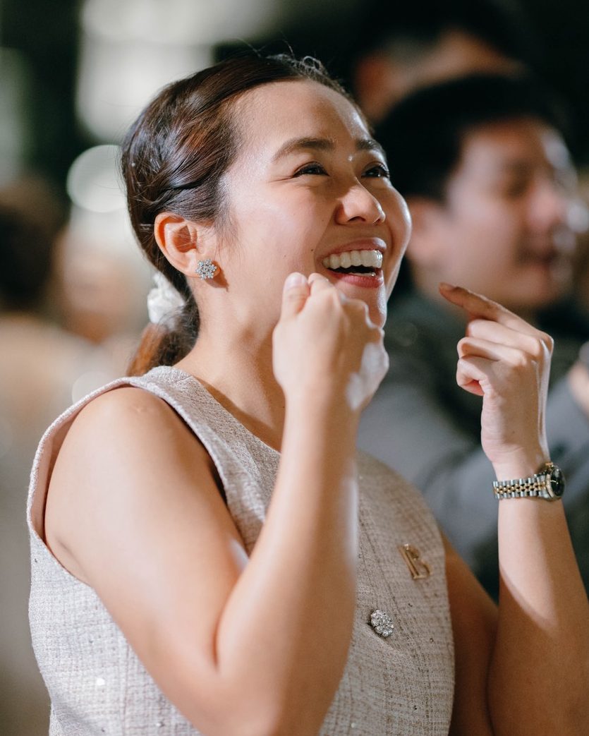Belle cheering and smiling during a wedding