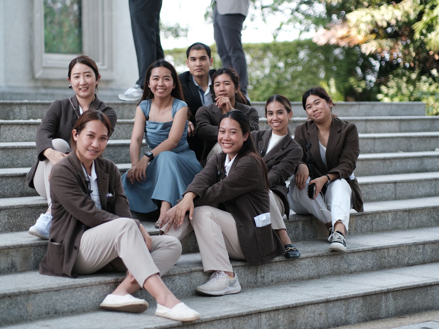 The BFF team smiling together on the steps of a venue